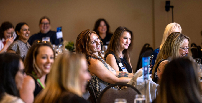 Woman smiling at a conference.